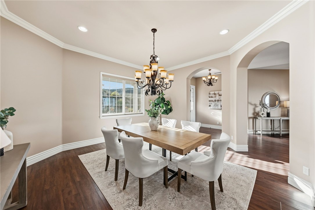 40267 Scanlon Road Temecula, CA 92592 - Photo 13 of 68 a dining room with furniture wooden floor a potted plant and a chandelier