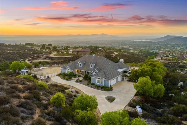 a view of a house with swimming pool and sitting area
