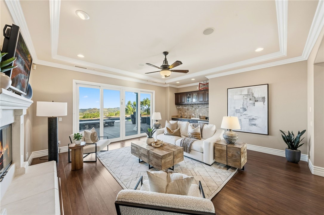 40267 Scanlon Road Temecula, CA 92592 - Photo 17 of 68 a living room with fireplace furniture and a wooden floor