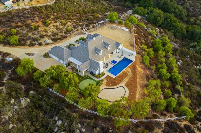 an aerial view of a house with a yard