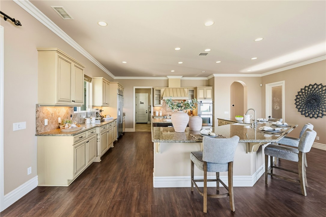 40267 Scanlon Road Temecula, CA 92592 - Photo 23 of 68 a living room with stainless steel appliances kitchen island granite countertop furniture wooden floor and a kitchen view