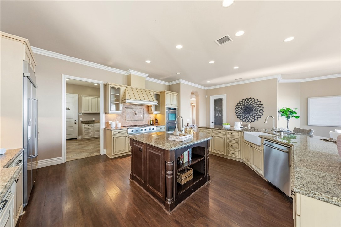 40267 Scanlon Road Temecula, CA 92592 - Photo 26 of 68 a kitchen with granite countertop a stove oven and cabinets