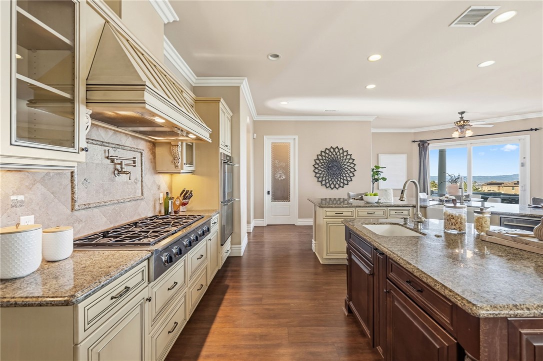 40267 Scanlon Road Temecula, CA 92592 - Photo 28 of 68 a kitchen with stainless steel appliances granite countertop a sink stove and cabinets