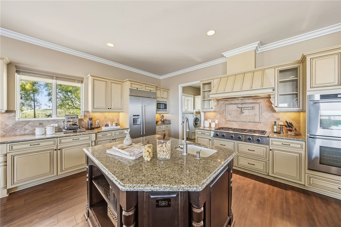 40267 Scanlon Road Temecula, CA 92592 - Photo 31 of 68 a kitchen with stainless steel appliances granite countertop a sink stove and cabinets