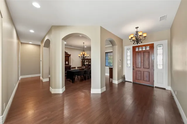 a view of a a dining room with furniture window and wooden floor