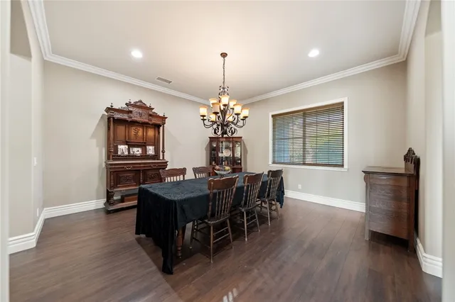 a bedroom with a bed and a table chair