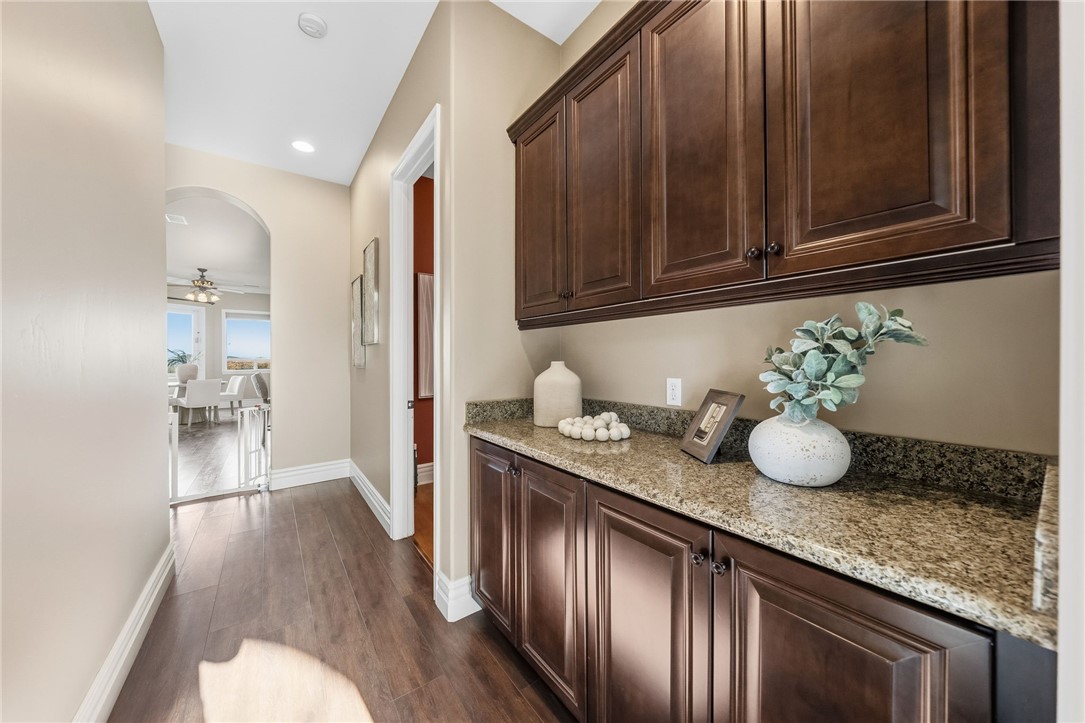 40267 Scanlon Road Temecula, CA 92592 - Photo 44 of 68 a kitchen with granite countertop a sink cabinets and wooden floor