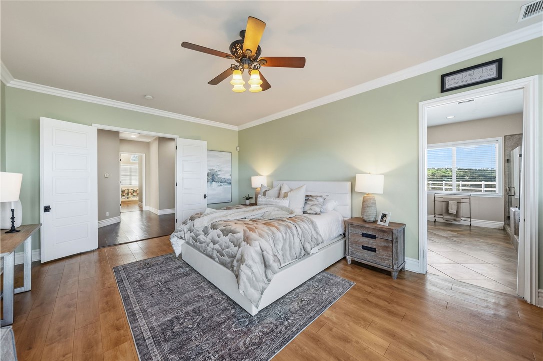 40267 Scanlon Road Temecula, CA 92592 - Photo 49 of 68 a spacious bedroom with a bed and a chandelier