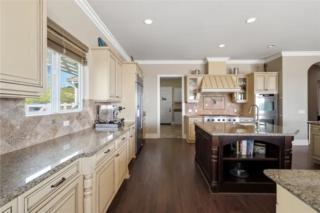 an aerial view of residential houses with outdoor space and ocean view