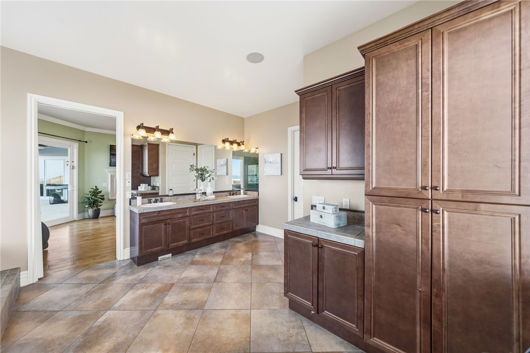 40267 Scanlon Road Temecula, CA 92592 - Photo 53 of 68 a large bathroom with a granite countertop tub sink and mirror