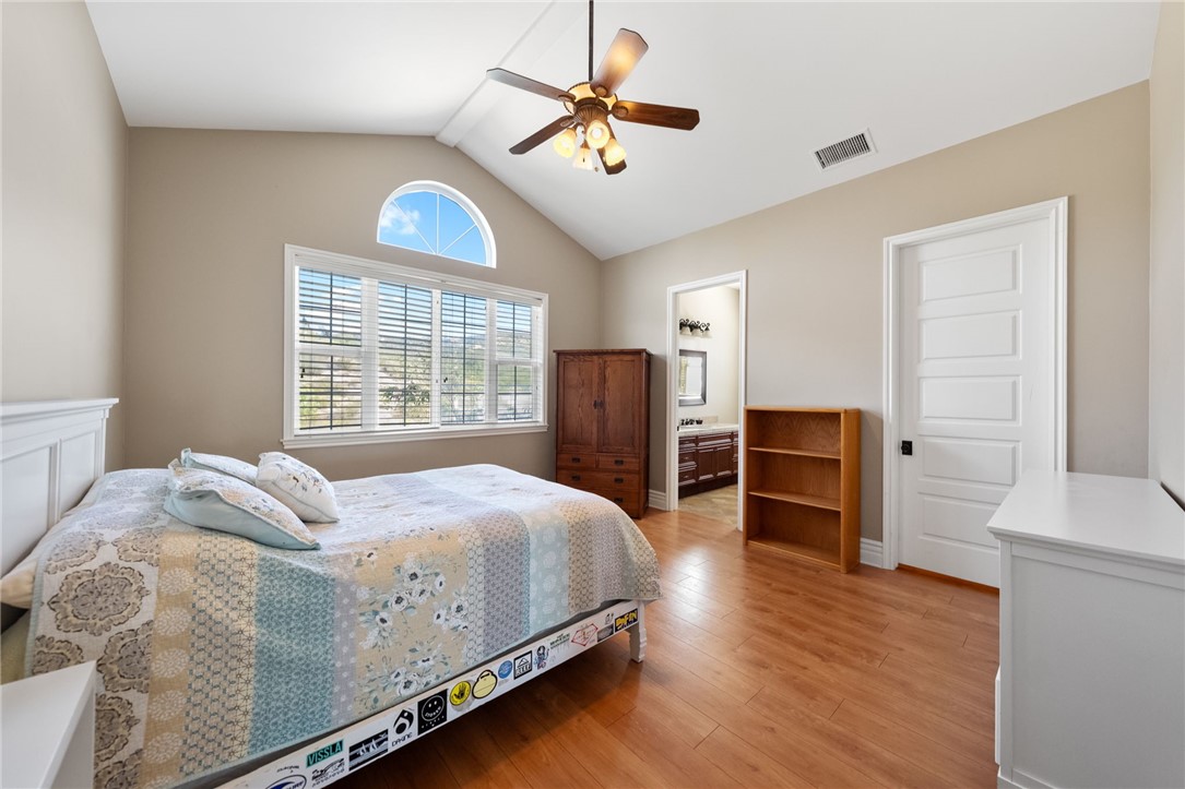 40267 Scanlon Road Temecula, CA 92592 - Photo 56 of 68 a bedroom with a bed and a chandelier