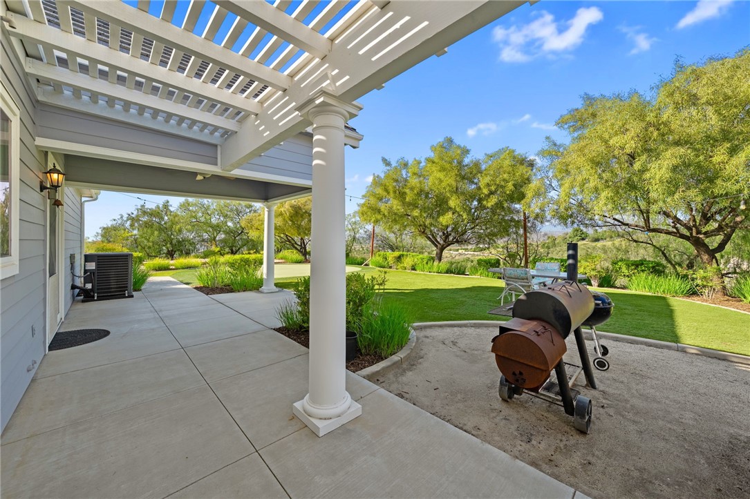 40267 Scanlon Road Temecula, CA 92592 - Photo 65 of 68 a view of a patio with table and chairs and a large tree