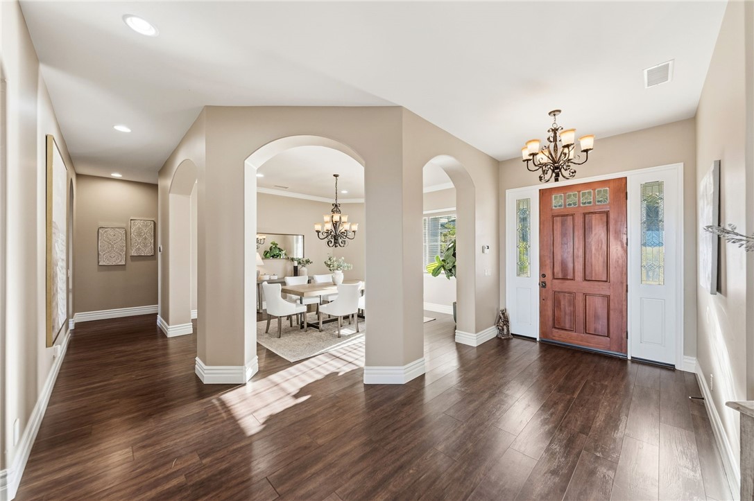 40267 Scanlon Road Temecula, CA 92592 - Photo 10 of 68 a view of a hallway with wooden floor and a living room