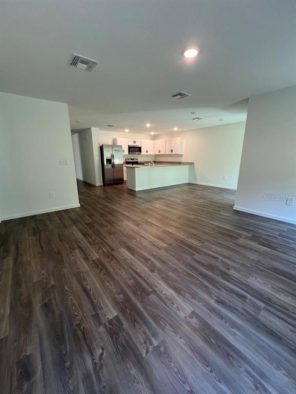 9131 Swiss Road Spring Hill, FL 34606 - Photo 11 of 16 a view of a room with wooden floor
