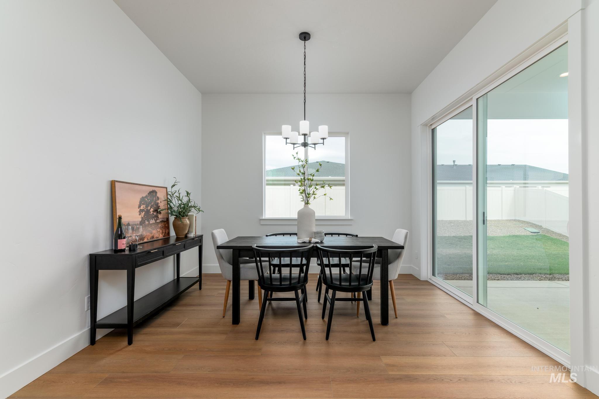 8558 South Silver Smog Way Meridian, ID 83642 - Photo 6 of 41 Modern fireplace featuring a classic white mantel, light-toned tile surround, and a black-framed insert