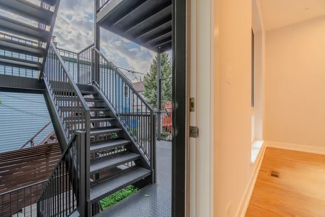 a view of entryway and hall with wooden floor