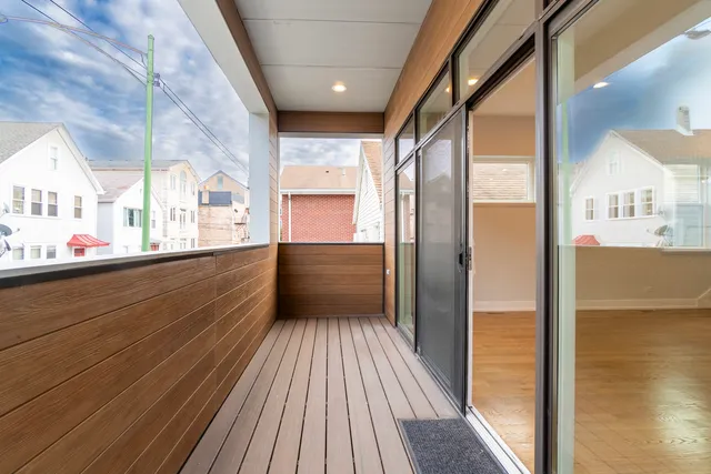 a view of a balcony with wooden floor