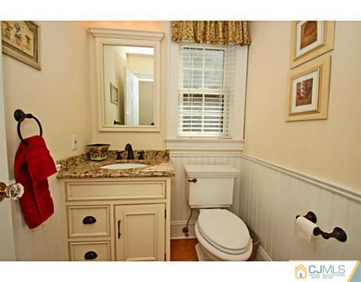 33 Edgewood Road Edison, NJ 08820 - Photo 12 of 25 a bathroom with a granite countertop toilet sink and mirror