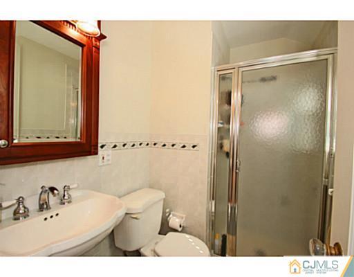 33 Edgewood Road Edison, NJ 08820 - Photo 15 of 25 a bathroom with a sink mirror vanity and toilet