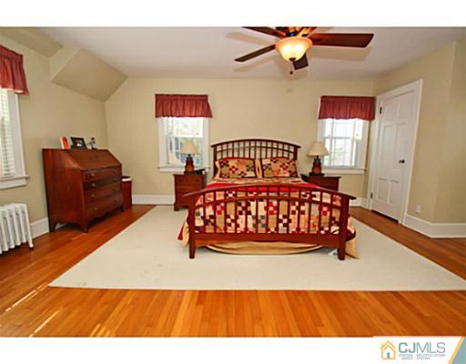 33 Edgewood Road Edison, NJ 08820 - Photo 16 of 25 a bedroom with a bed and wooden floor
