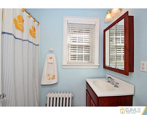 33 Edgewood Road Edison, NJ 08820 - Photo 20 of 25 a bathroom with a sink a mirror and a window