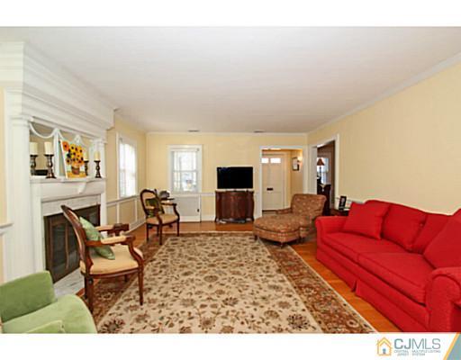 33 Edgewood Road Edison, NJ 08820 - Photo 4 of 25 a living room with furniture and a fireplace