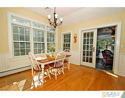 33 Edgewood Road Edison, NJ 08820 - Photo 10 of 25 a dining room with furniture a chandelier and wooden floor