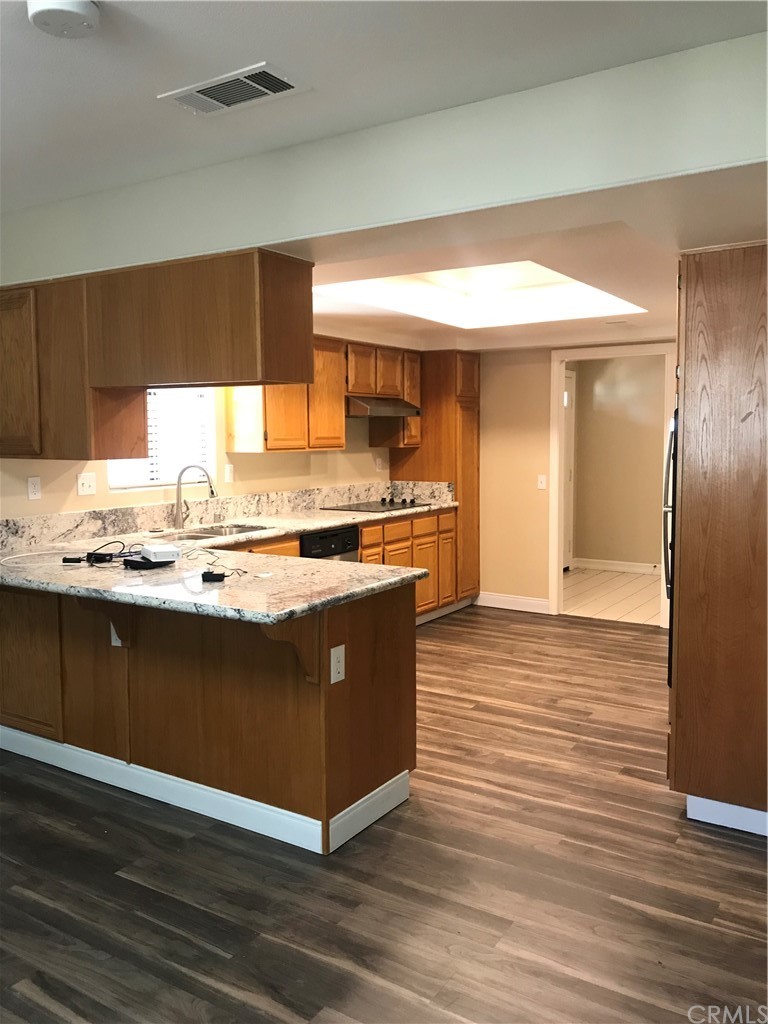 21050 Vandenberg Riverside, CA 92518 - Photo 3 of 24 a view of kitchen with stainless steel appliances granite countertop wooden cabinets and a counter top space