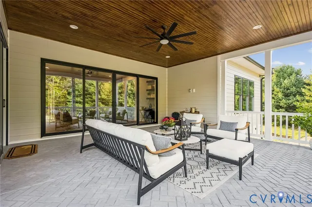 a balcony with furniture and wooden floor