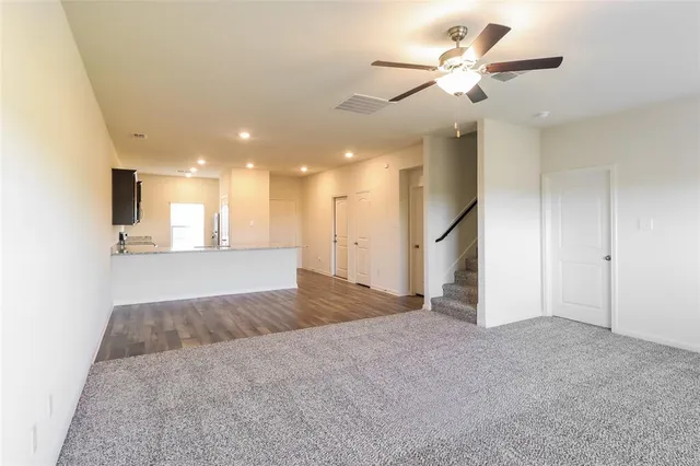 a view of a kitchen with a ceiling fan and kitchen view
