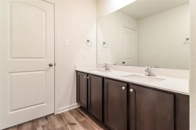 a bathroom with a double vanity sink and a mirror