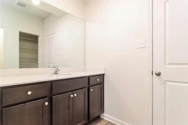 a bathroom with a double vanity sink and mirror