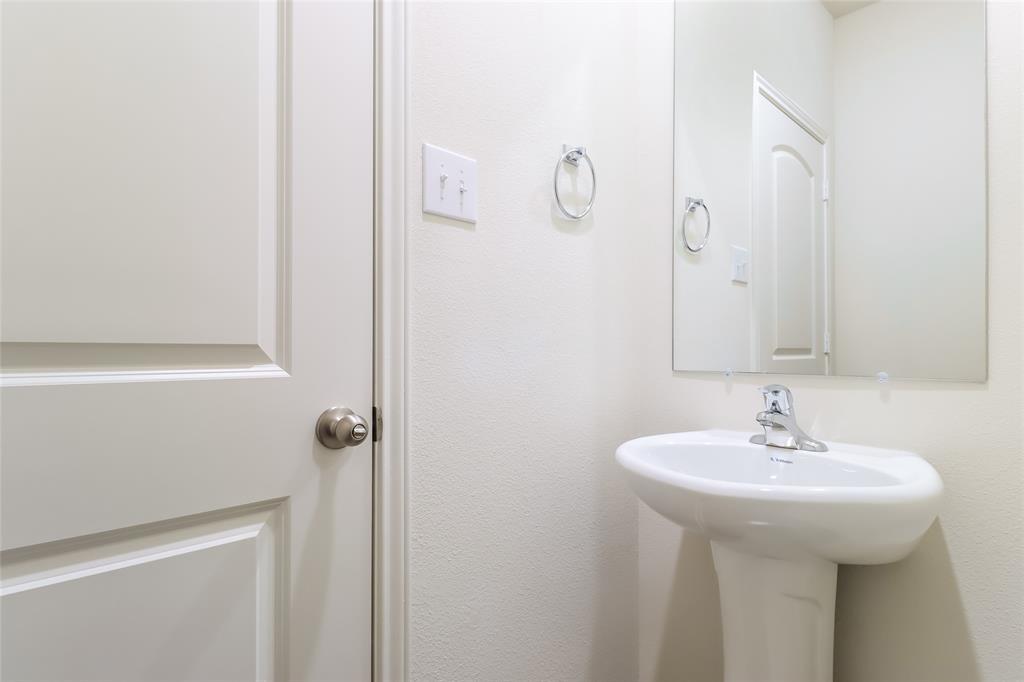 209 Switchback Hill Road Newark, TX 76071 - Photo 10 of 17 a bathroom with a sink and a mirror