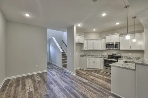 a kitchen with a refrigerator and a stove top oven