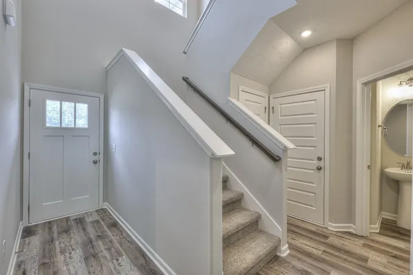 a view of entryway and hall with wooden floor