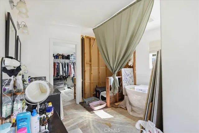 a bathroom with a sink toilet mirror vanity and shower