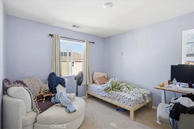 a bedroom with bed and a window