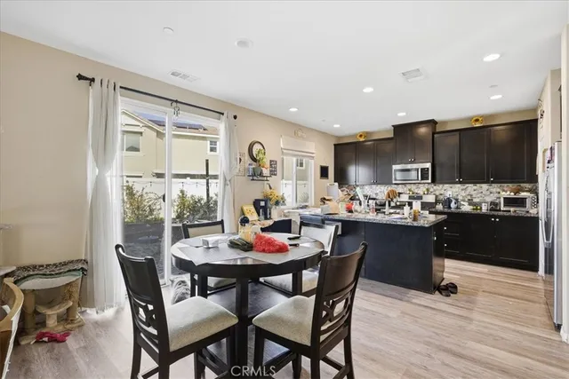 a view of a dining room with furniture kitchen and wooden floor
