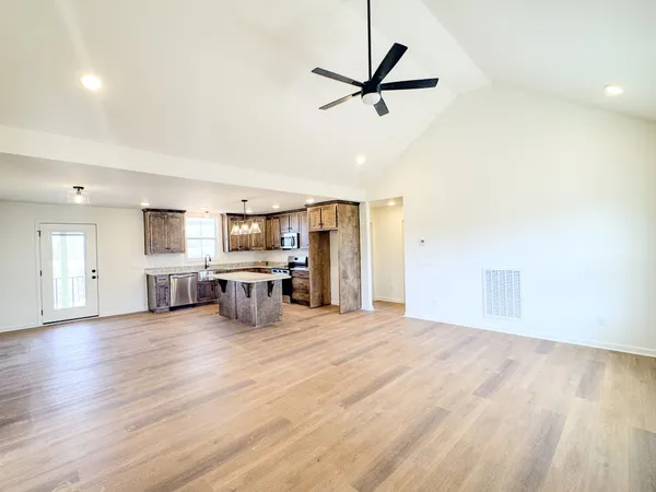 a view of a livingroom with furniture and a ceiling fan