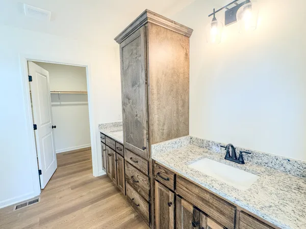 a bathroom with a granite countertop sink and a mirror