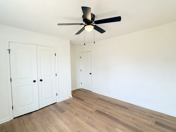 a view of empty room with wooden floor