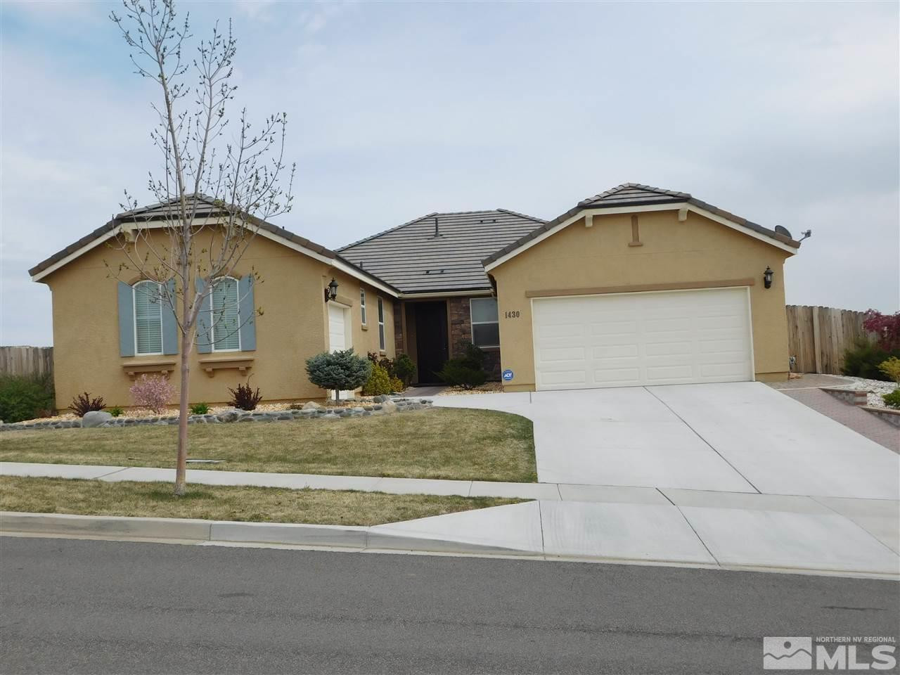 1430 Hogadon Way Reno, NV 89523 - Photo 1 of 1 a front view of a house with a yard and garage