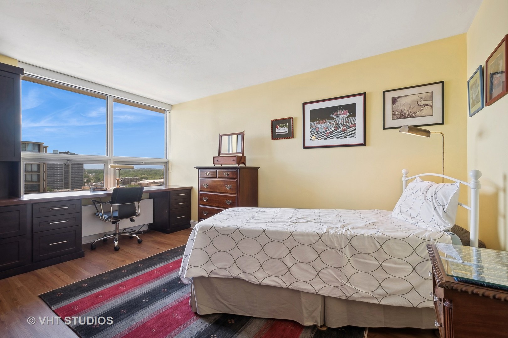 5733 North Sheridan Road, Unit 16A Chicago, IL 60660 - Photo 11 of 29 a bedroom with a bed and wooden floor