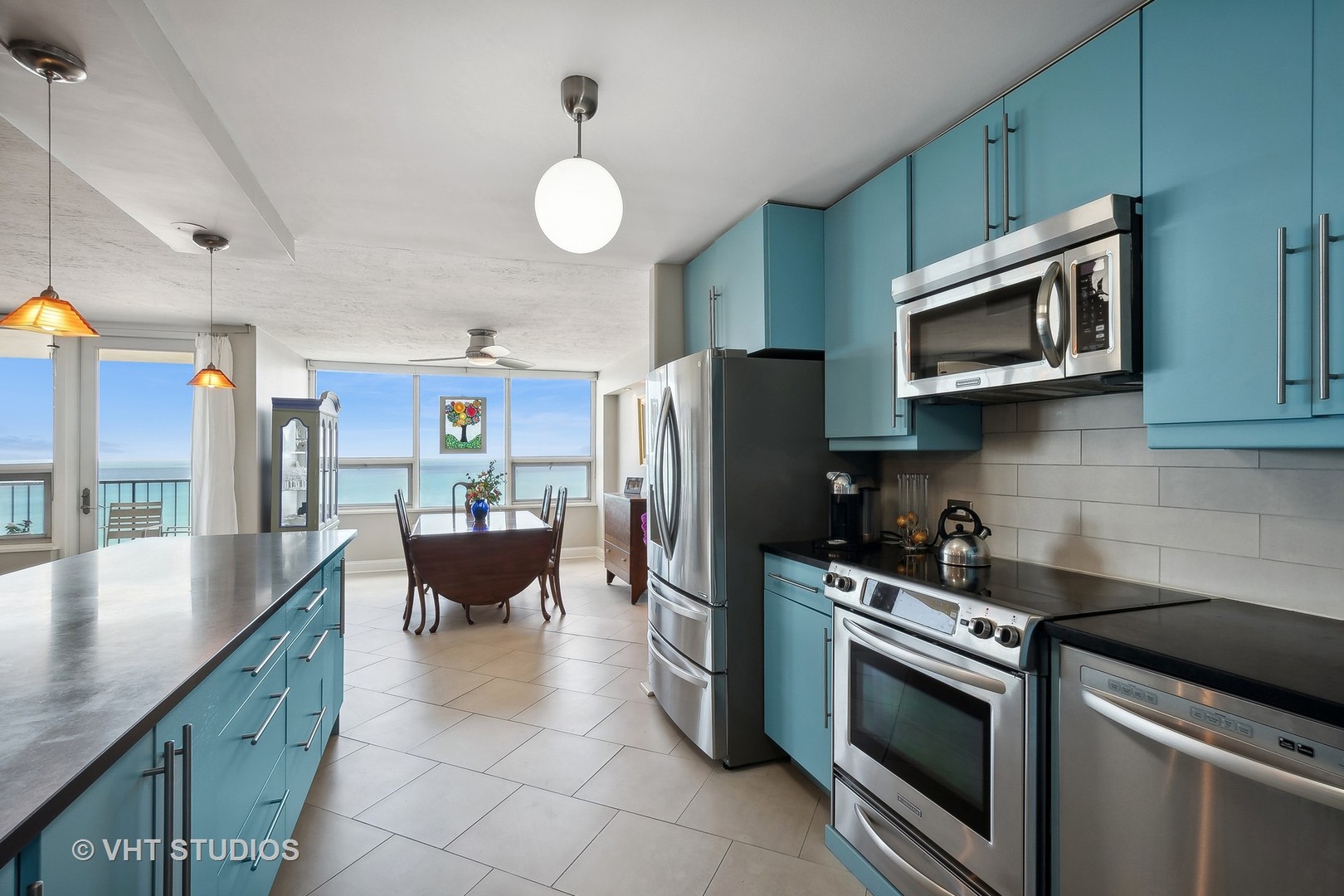 5733 North Sheridan Road, Unit 16A Chicago, IL 60660 - Photo 12 of 29 a kitchen with stainless steel appliances granite countertop a stove microwave and refrigerator