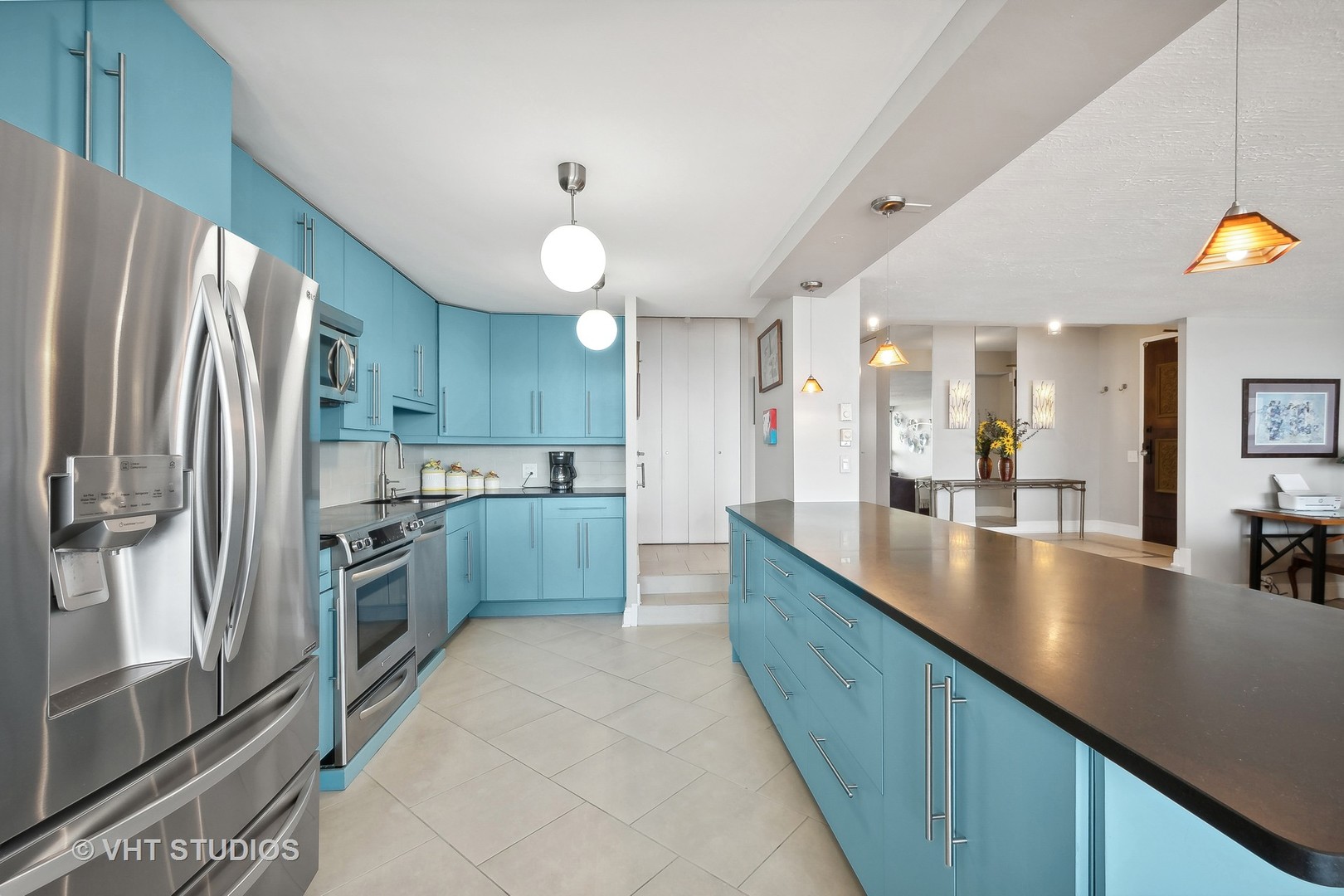 5733 North Sheridan Road, Unit 16A Chicago, IL 60660 - Photo 13 of 29 a large kitchen with stainless steel appliances and a large counter top