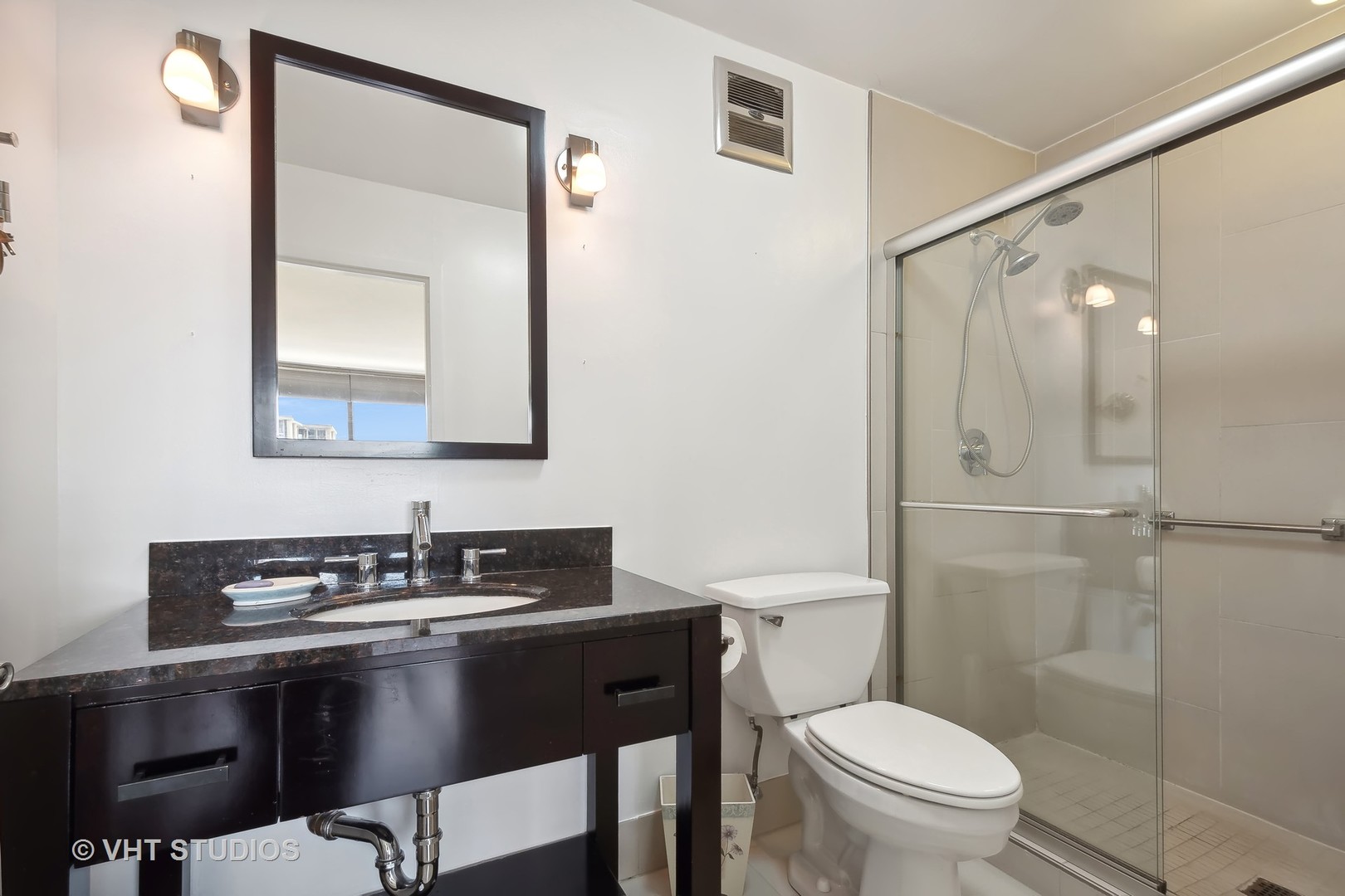 5733 North Sheridan Road, Unit 16A Chicago, IL 60660 - Photo 16 of 29 a bathroom with a sink a toilet a mirror and shower