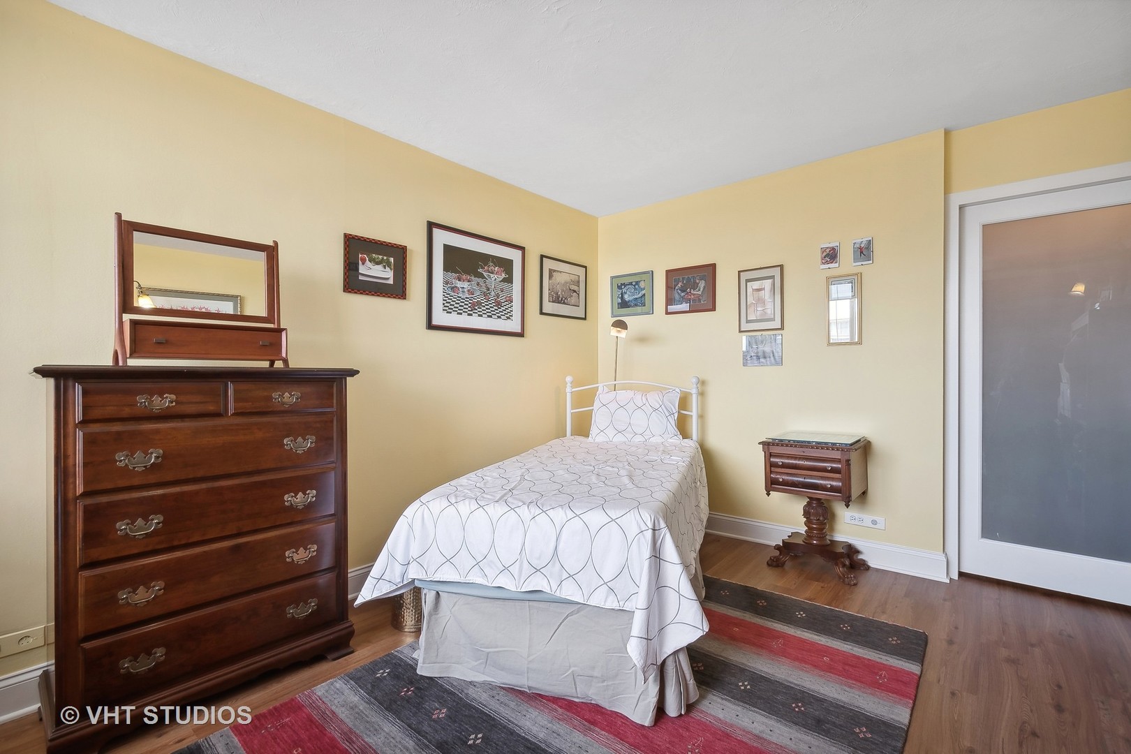 5733 North Sheridan Road, Unit 16A Chicago, IL 60660 - Photo 18 of 29 a bedroom with a bed and wooden floor