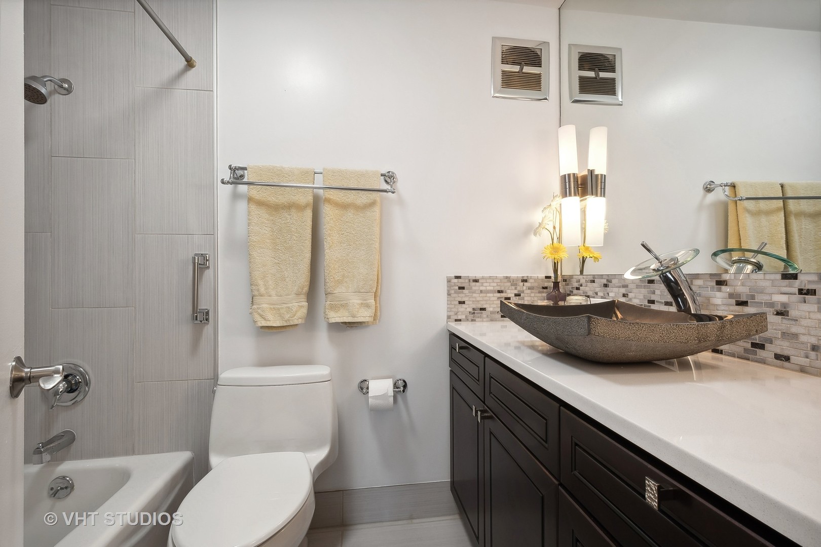 5733 North Sheridan Road, Unit 16A Chicago, IL 60660 - Photo 19 of 29 a bathroom with a sink double vanity and a toilet