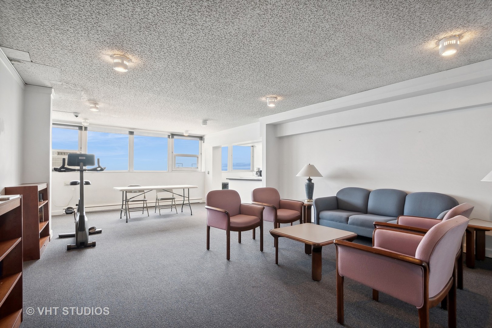 5733 North Sheridan Road, Unit 16A Chicago, IL 60660 - Photo 28 of 29 a living room with furniture a flat screen tv and a table