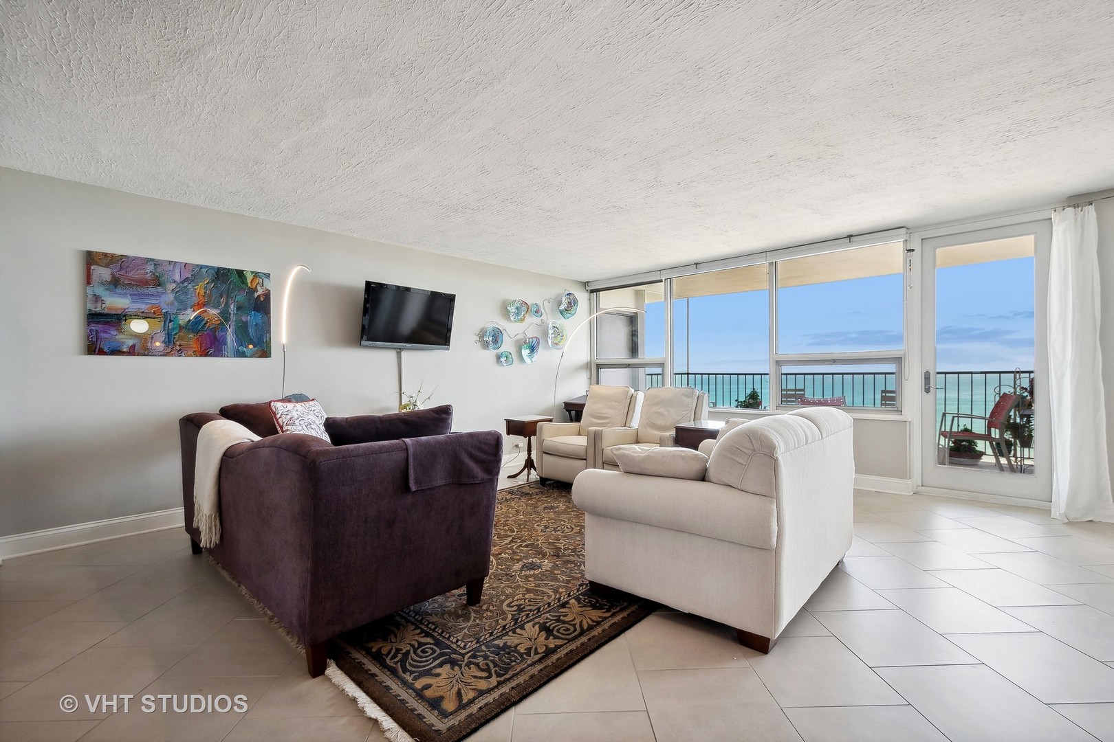 5733 North Sheridan Road, Unit 16A Chicago, IL 60660 - Photo 5 of 29 a living room with furniture and a flat screen tv